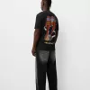Blekt kortärmad T-shirt med AC/DC-tryck Blekt kortärmad T-shirt med AC/DC-tryck