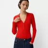 Långärmad bodysuit med utskuren polokrage Långärmad bodysuit med utskuren polokrage